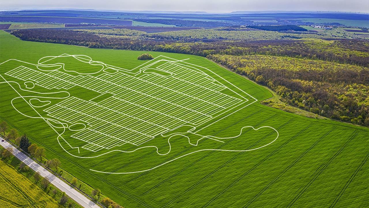 Line drawing of a solar site layout over a green field