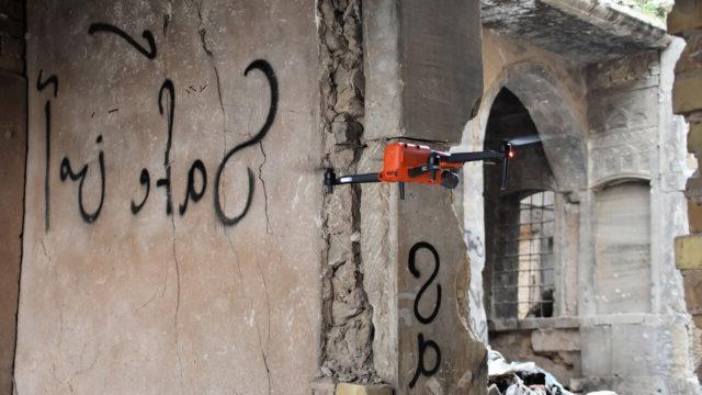 A drone piloted by Tetra Tech scanning a damaged building for improvised explosive devices (IEDs)